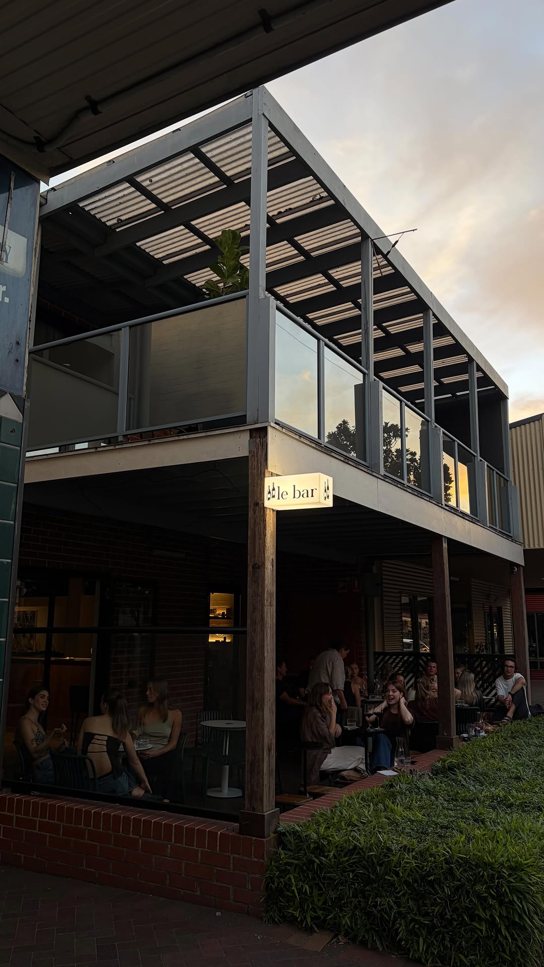 Le bar. storefront at dusk, Queen Street Berry
